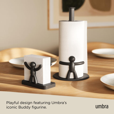 In-use Umbra Buddy napkin holder on a dining table for easy reach.
