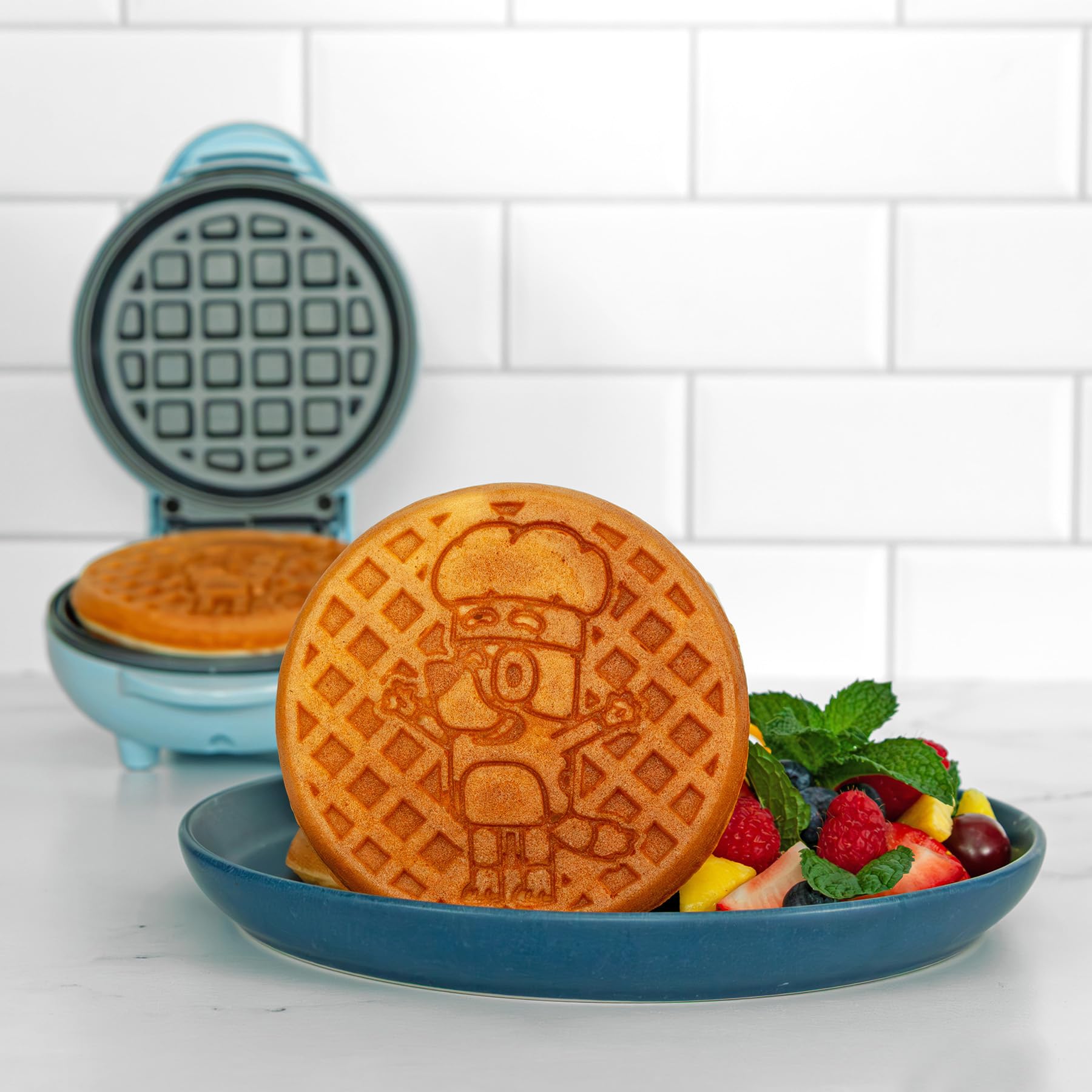 Uncanny Brands Bluey Mini Waffle Maker in use during a playful breakfast routine