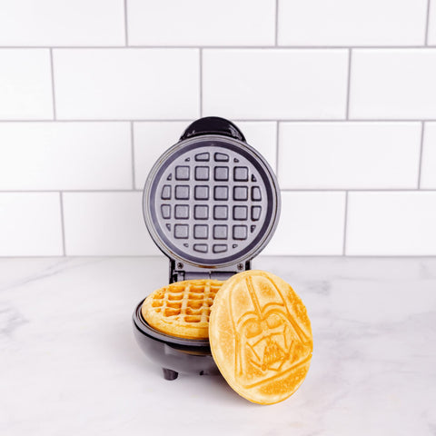 Uncanny Brands Darth Vader mini waffle maker non-stick plates for quick cleanup.