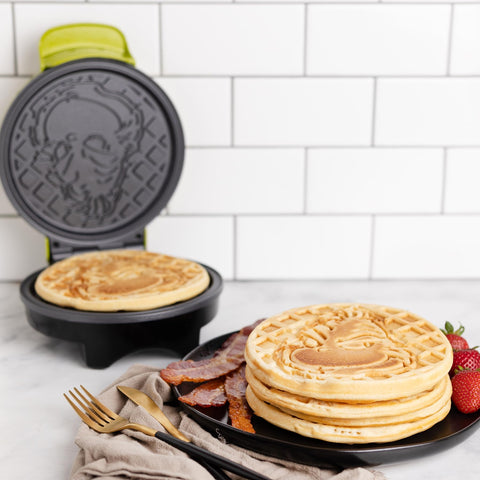 Uncanny Brands Grinch waffle maker gift idea sparks joyful kitchen creativity.