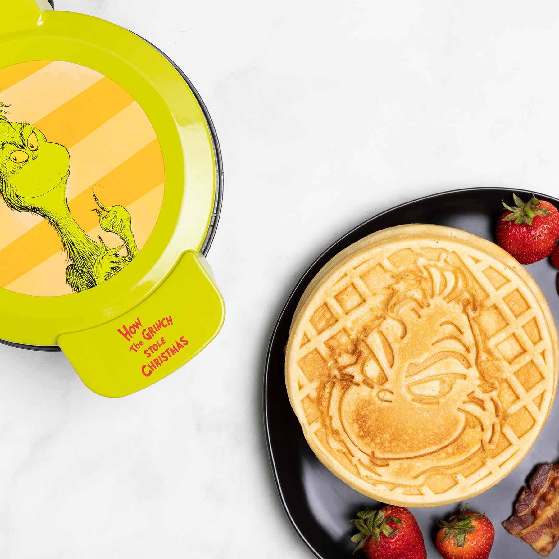 Uncanny Brands Grinch waffle maker lid imprint showcasing The Grinch for festive breakfasts.