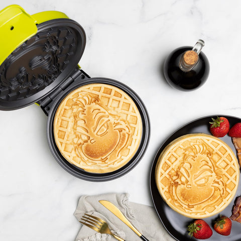 Uncanny Brands Grinch waffle maker silhouette imprint creates playful waffles every morning.