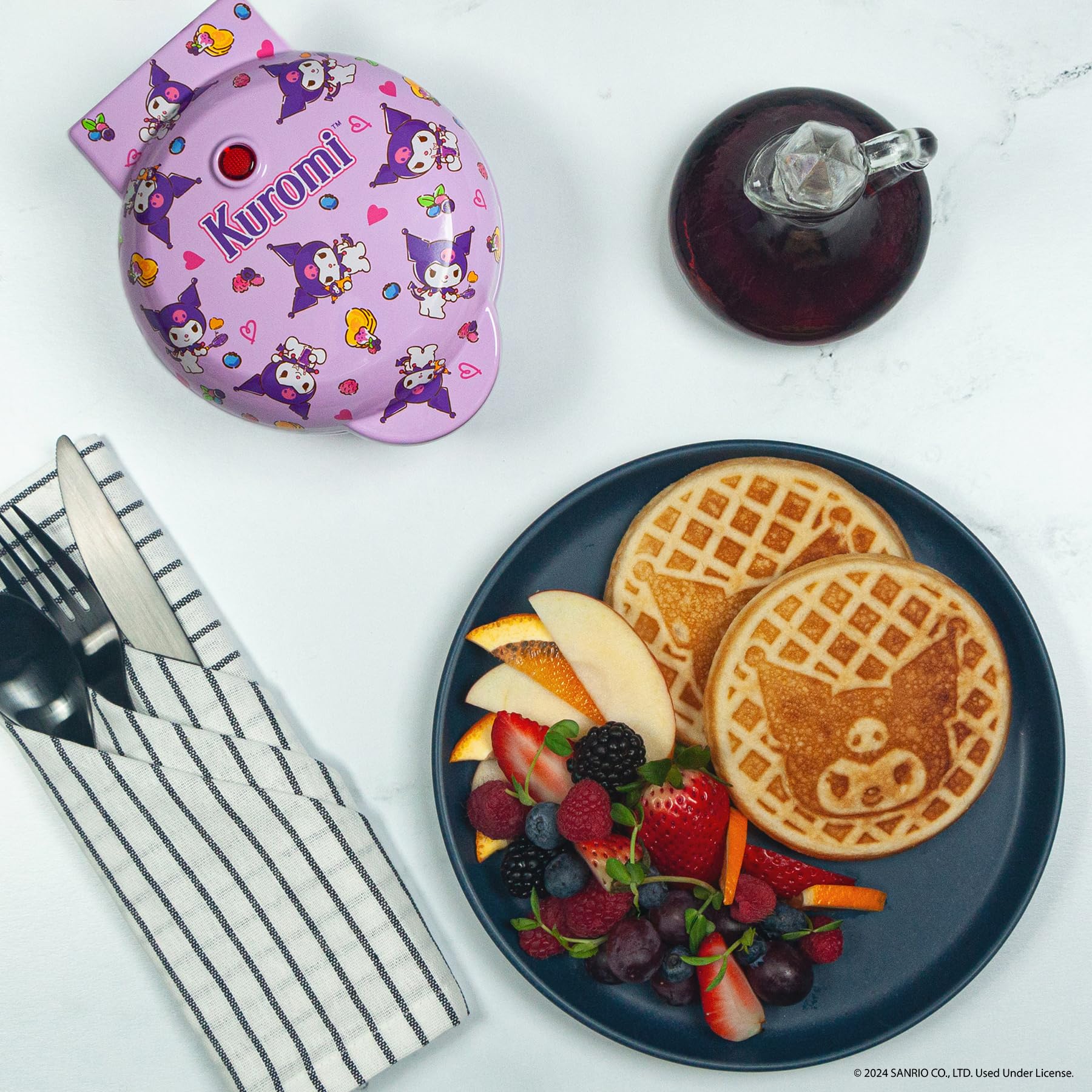 Uncanny Brands Hello Kitty Kuromi mini waffle maker on countertop, compact design for small kitchens.