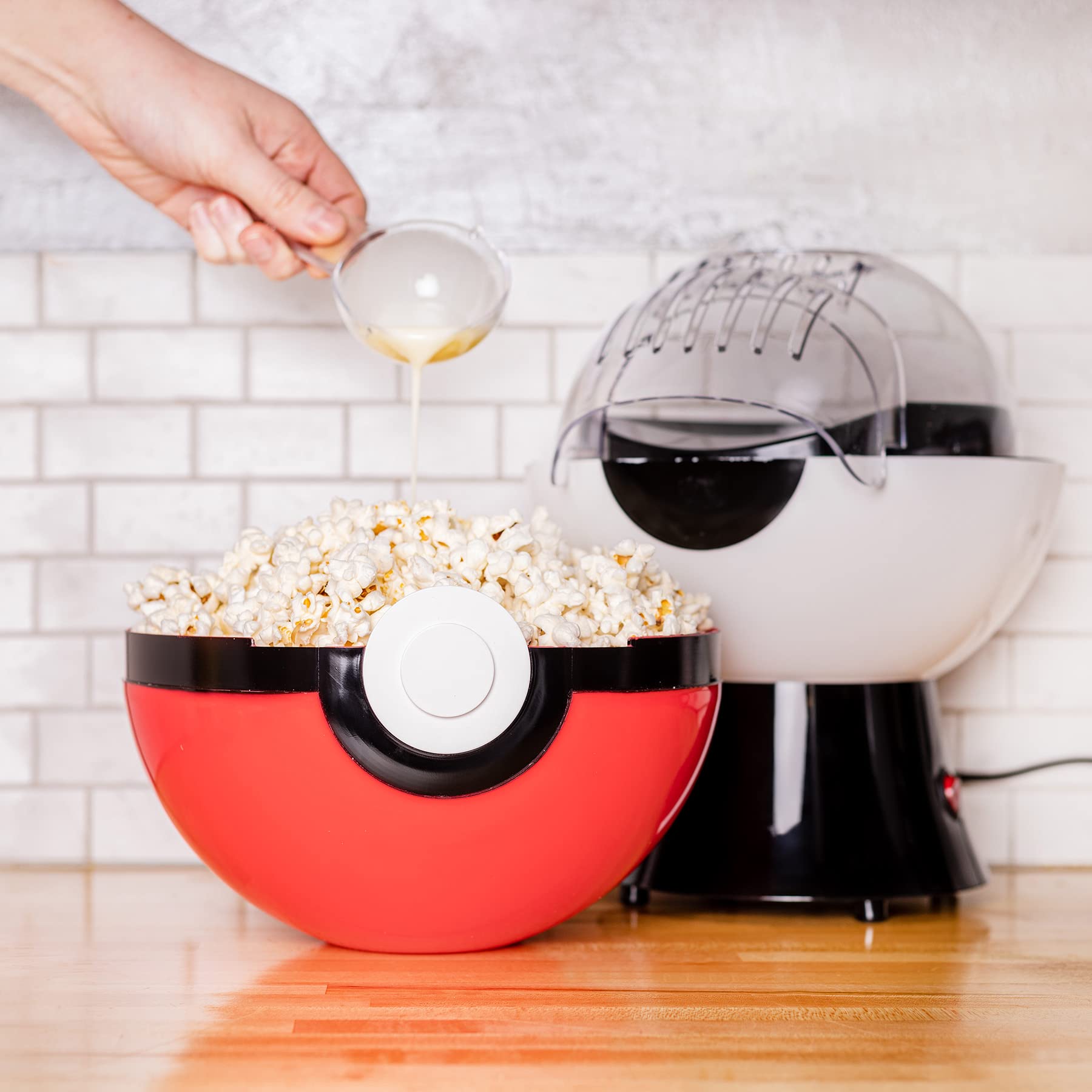 Uncanny Brands Poké Ball Popcorn Maker in action popping kernels quickly