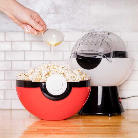 Uncanny Brands Poké Ball Popcorn Maker in action popping kernels quickly