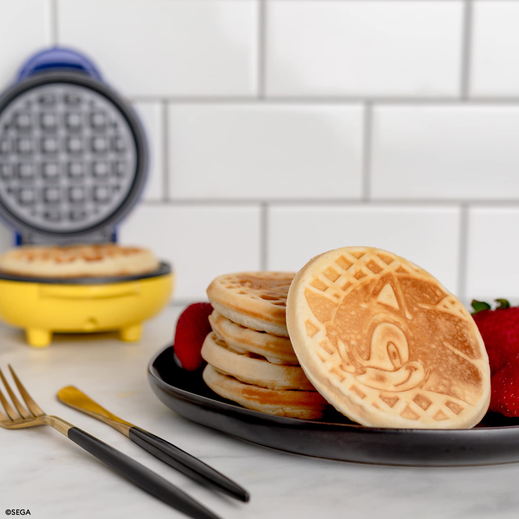 Uncanny Brands Sonic waffle maker plates show a non-stick surface for easy cleanup.