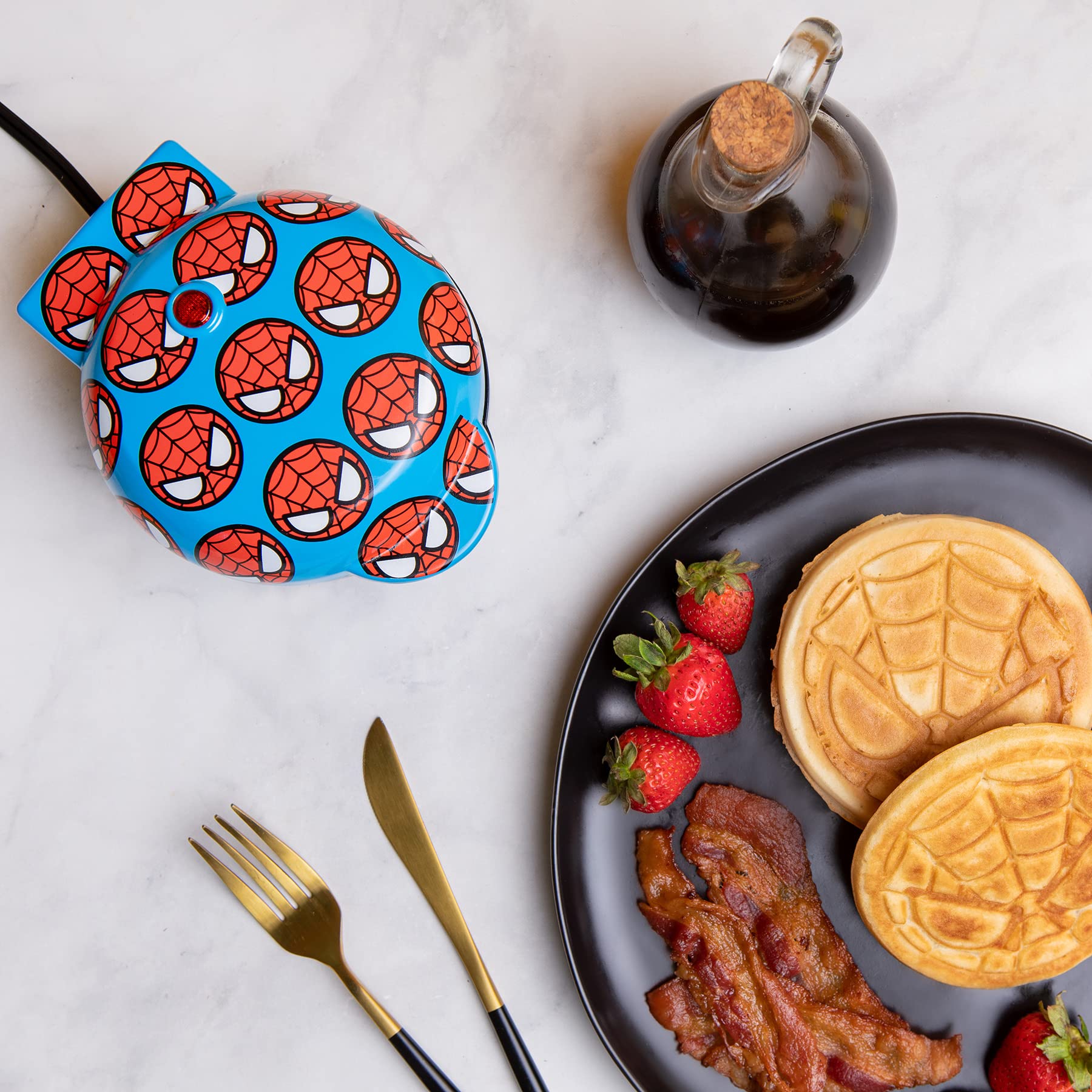 Uncanny Brands Spider-Man mini waffle maker lid art adds playful decor and quick waffles.