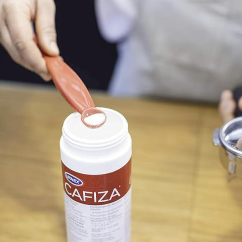 Urnex Cafiza easy rinsing formula in use with espresso equipment