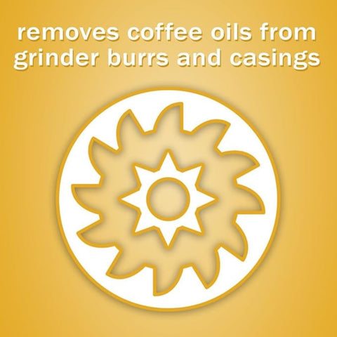 Urnex Grindz tablets in use cleaning a standard coffee grinder.