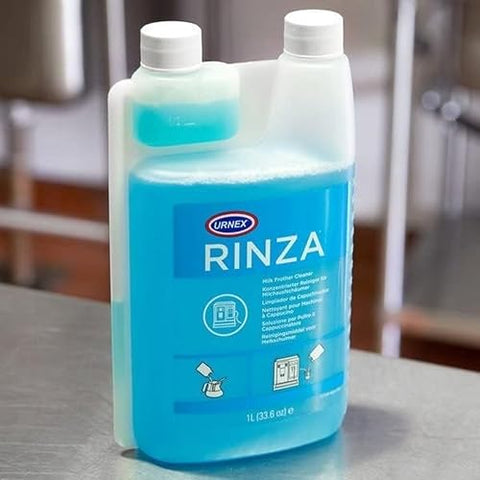 Urnex Rinza cleaner beside steam wand for traditional wand cleaning.