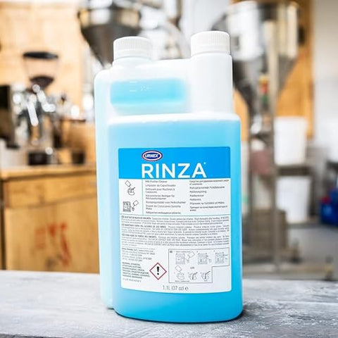 Urnex Rinza with steel pitcher for pitcher cleaning.