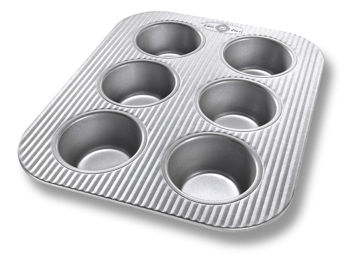 USA Pan 6-cup muffin pan in aluminized steel delivering even heat for consistent muffins.