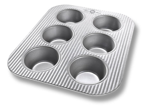 USA Pan 6-cup muffin pan in aluminized steel delivering even heat for consistent muffins.