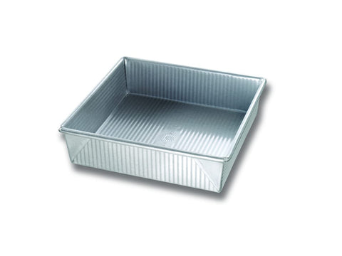 USA Pan 9-inch square pan with corrugated surface for even browning and easy release.