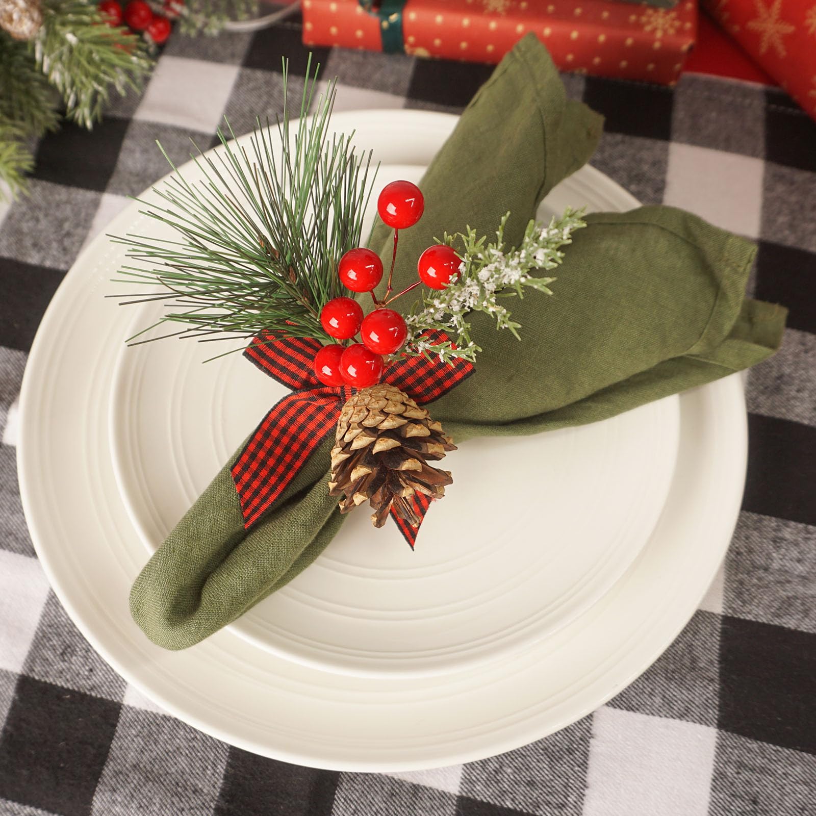 Utalek Christmas table scene starter with pine cones and berries.