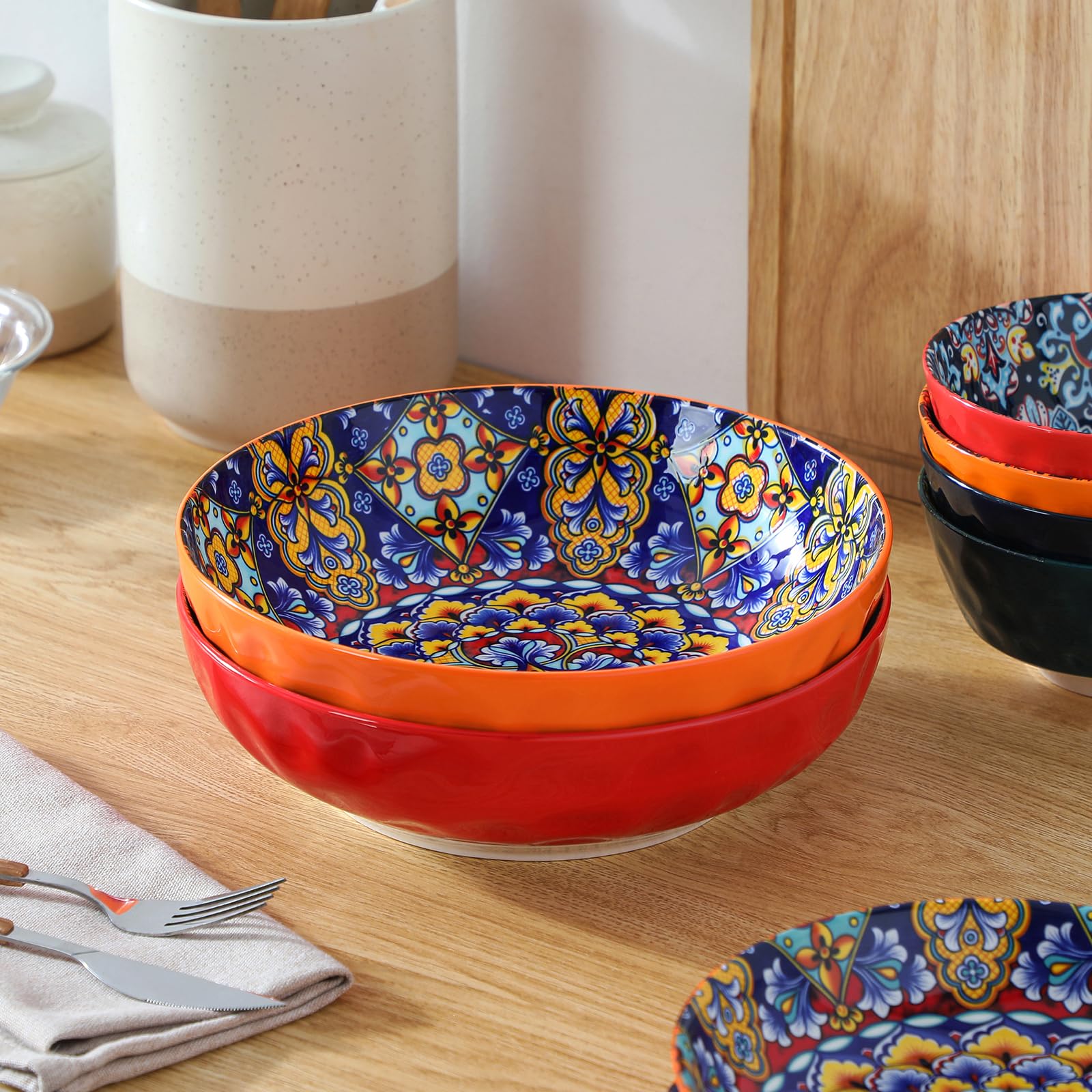 Vancasso red Boho bowls create a colorful centerpiece on tables.