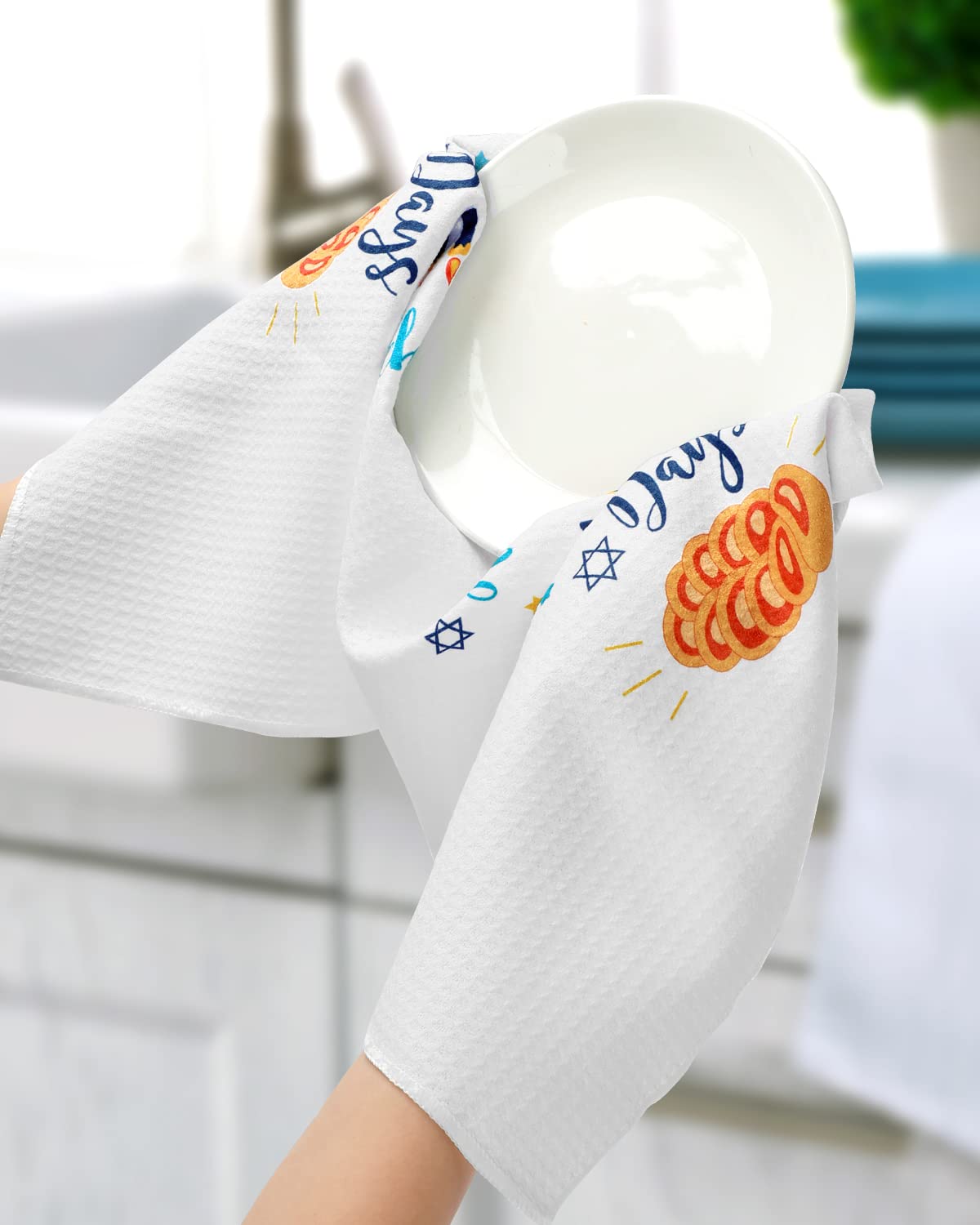 Vansolinne Hanukkah towels on countertop as stylish seasonal decor.