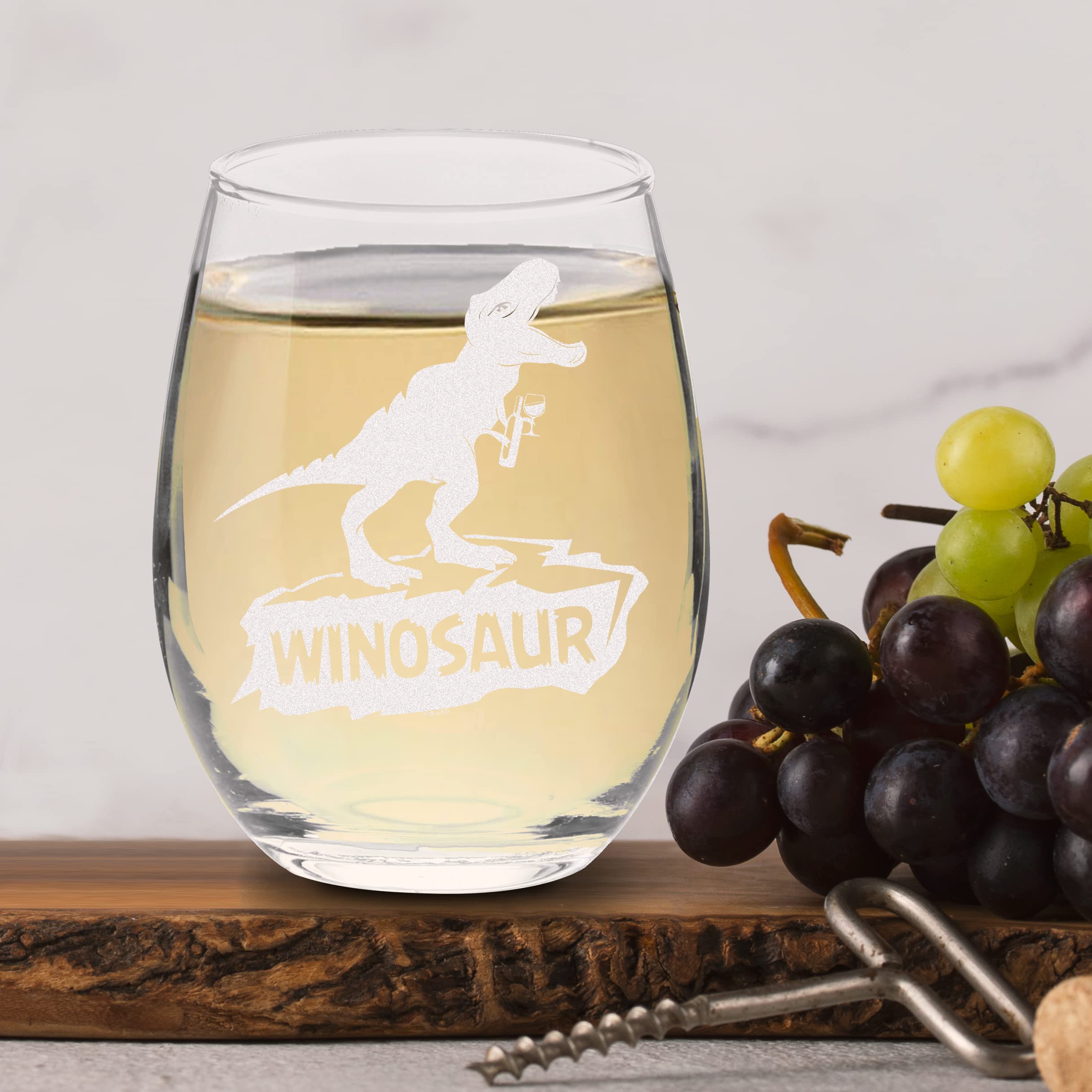 Table-ready glass on a festive table with dinosaur motif.