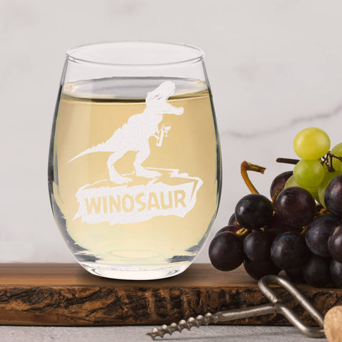 Table-ready glass on a festive table with dinosaur motif.