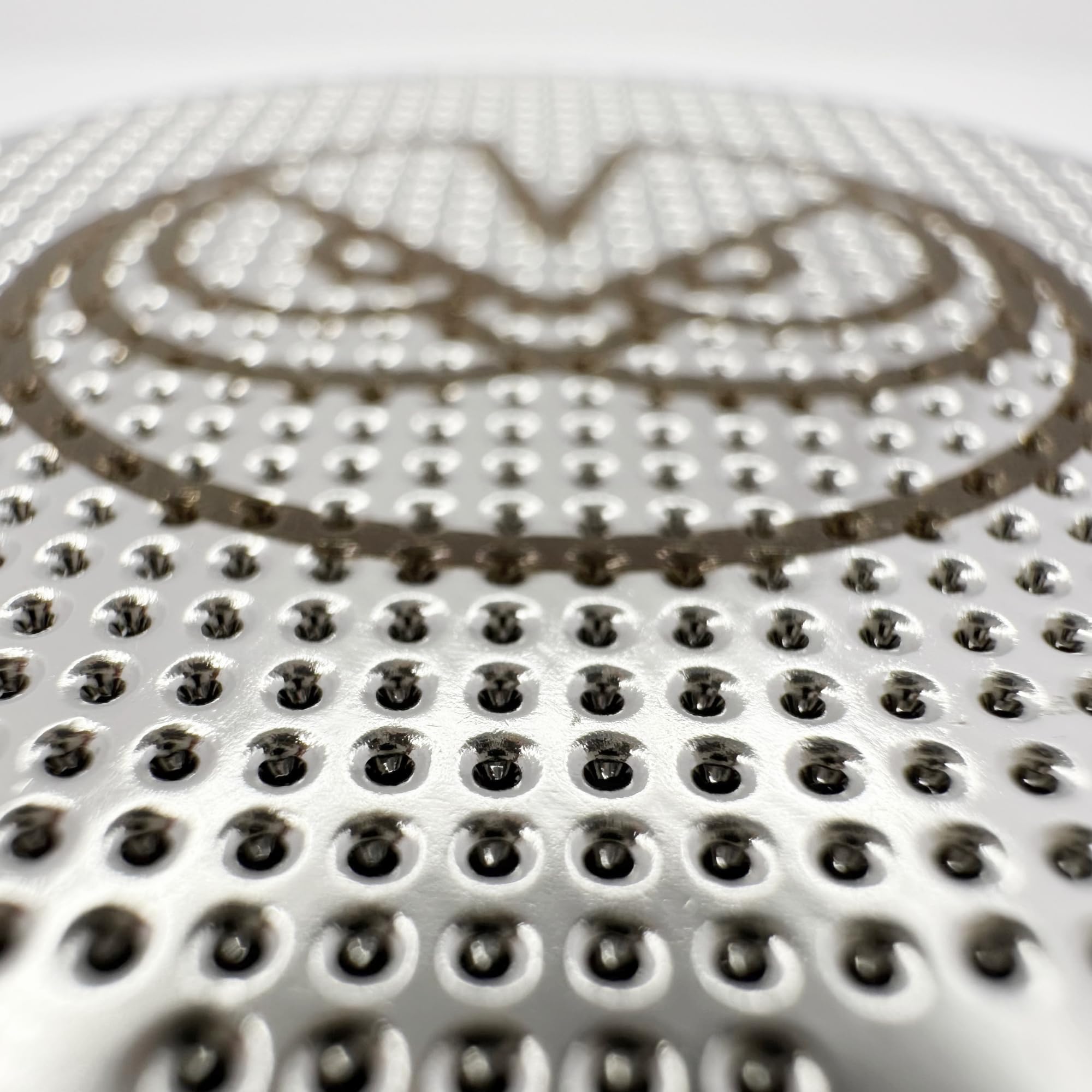 Detailed hole pattern designed to optimize water distribution and extraction.