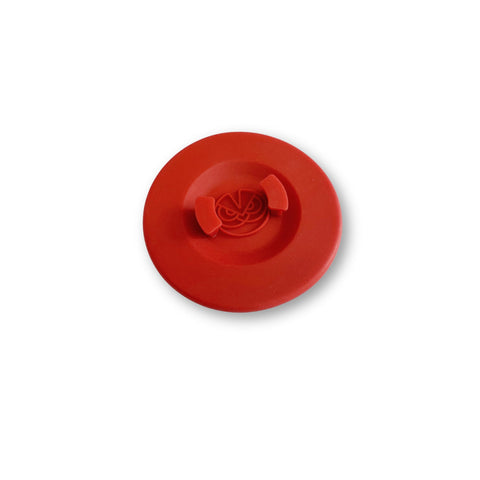 Silicone backflush disc with logo grip for secure handling during cleaning.