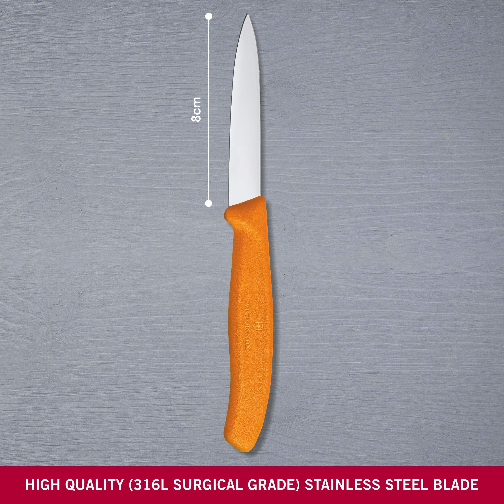Close-up of Victorinox paring knife showing ergonomic orange grip.