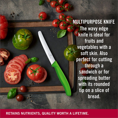 Victorinox tomato knife with green handle on cutting board, versatile kitchen tool.