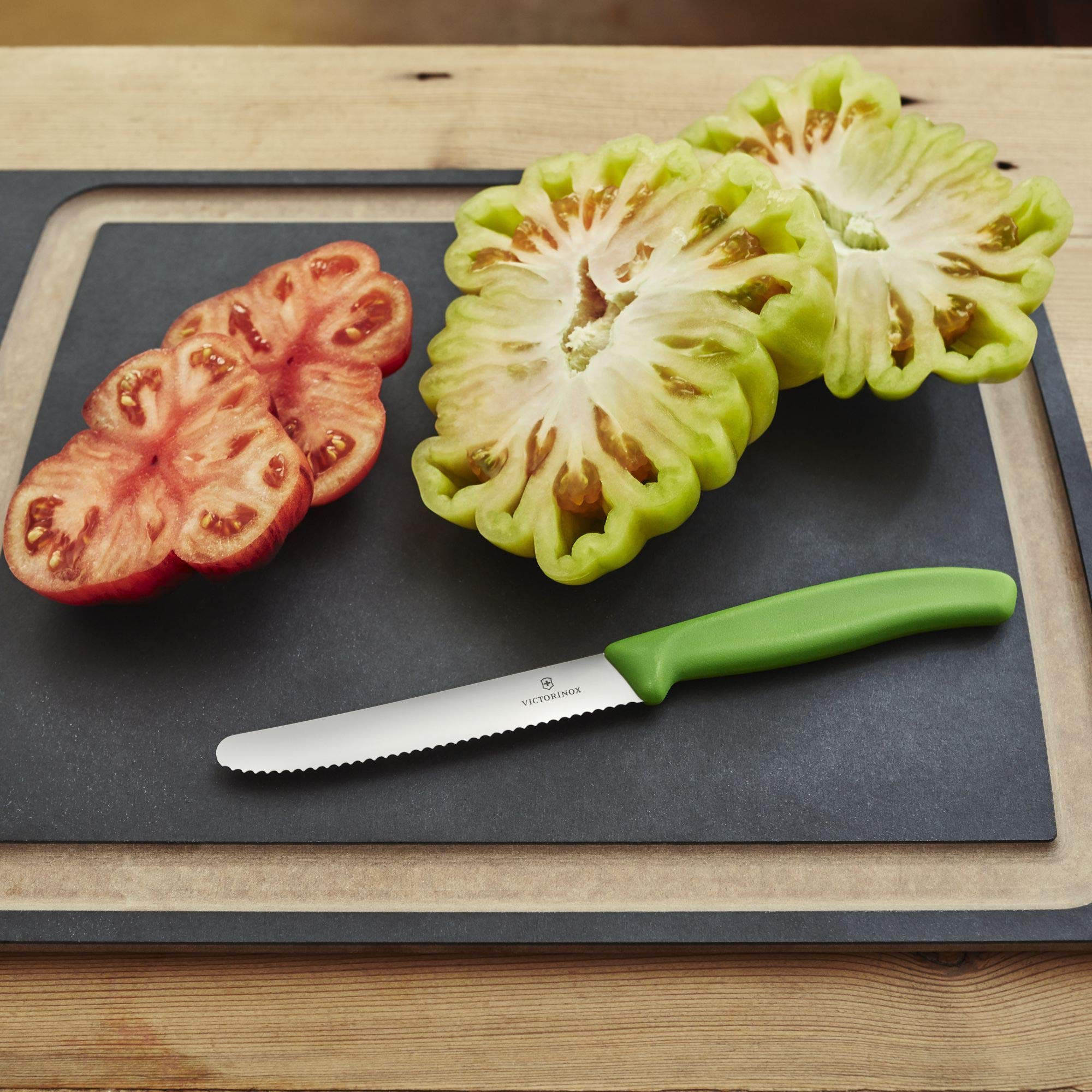 Victorinox tomato knife with green handle, compact size ideal for small produce prep.