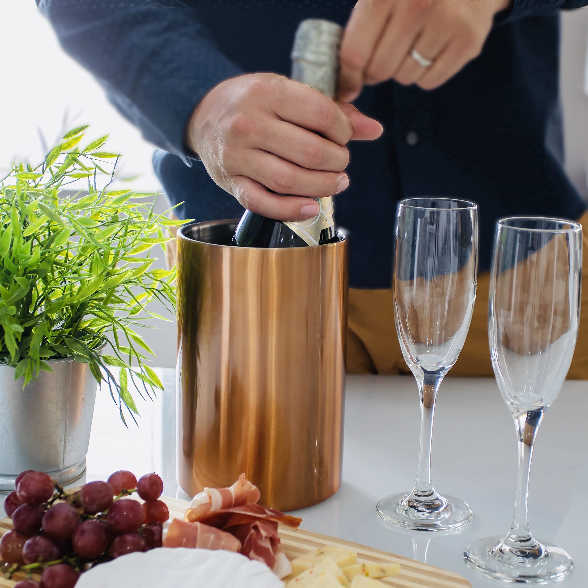 Villa & Marx wine chiller on table with glass, stylish entertaining.