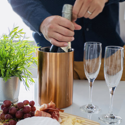 Villa & Marx wine chiller on table with glass, stylish entertaining.