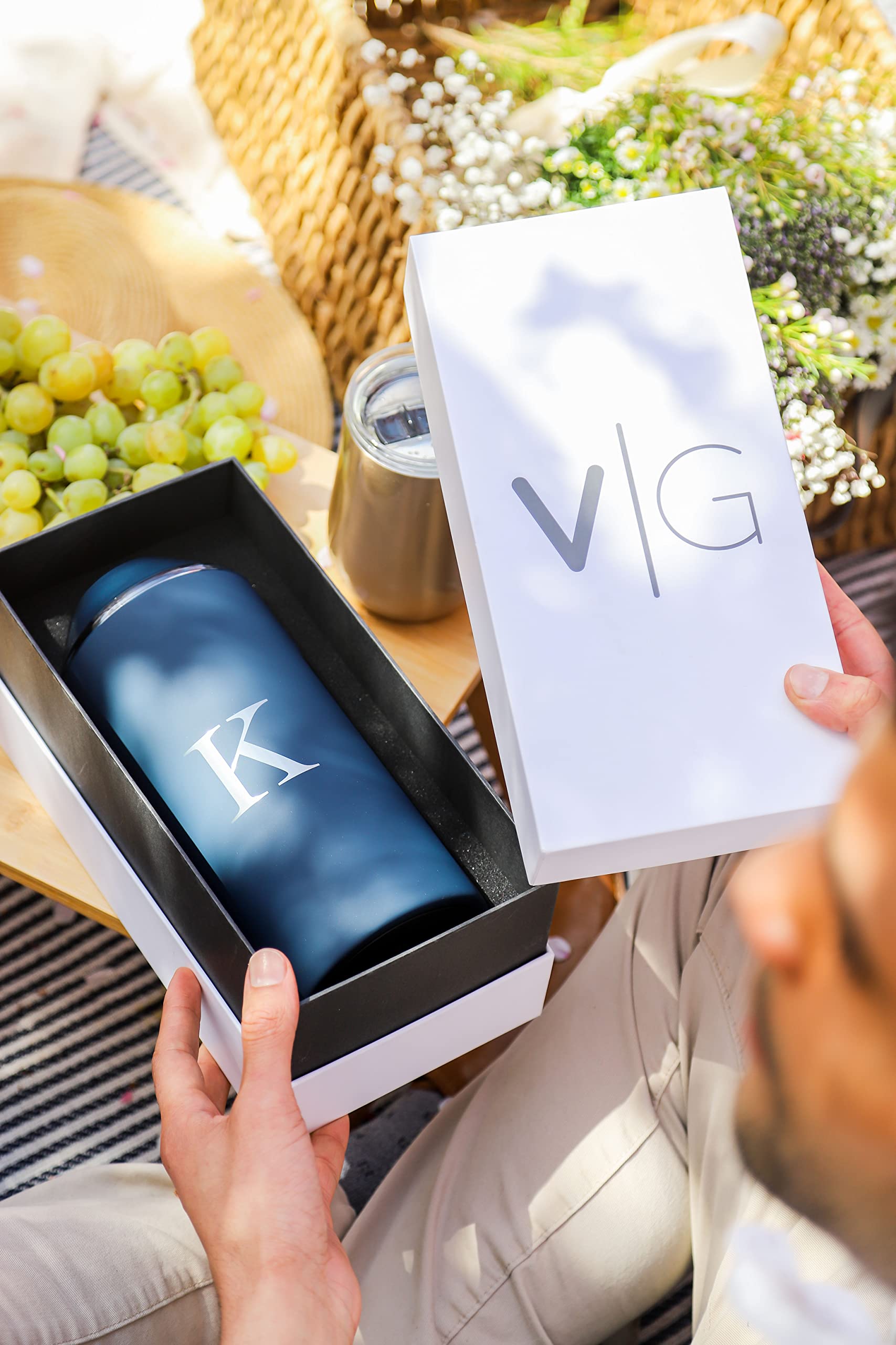 Vinglacé navy chiller beside a glass of wine on table