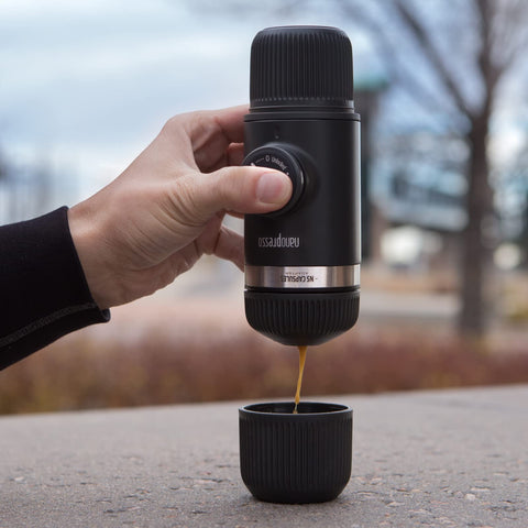 Manual pumping action shows pressure for dense espresso crema using ground coffee.