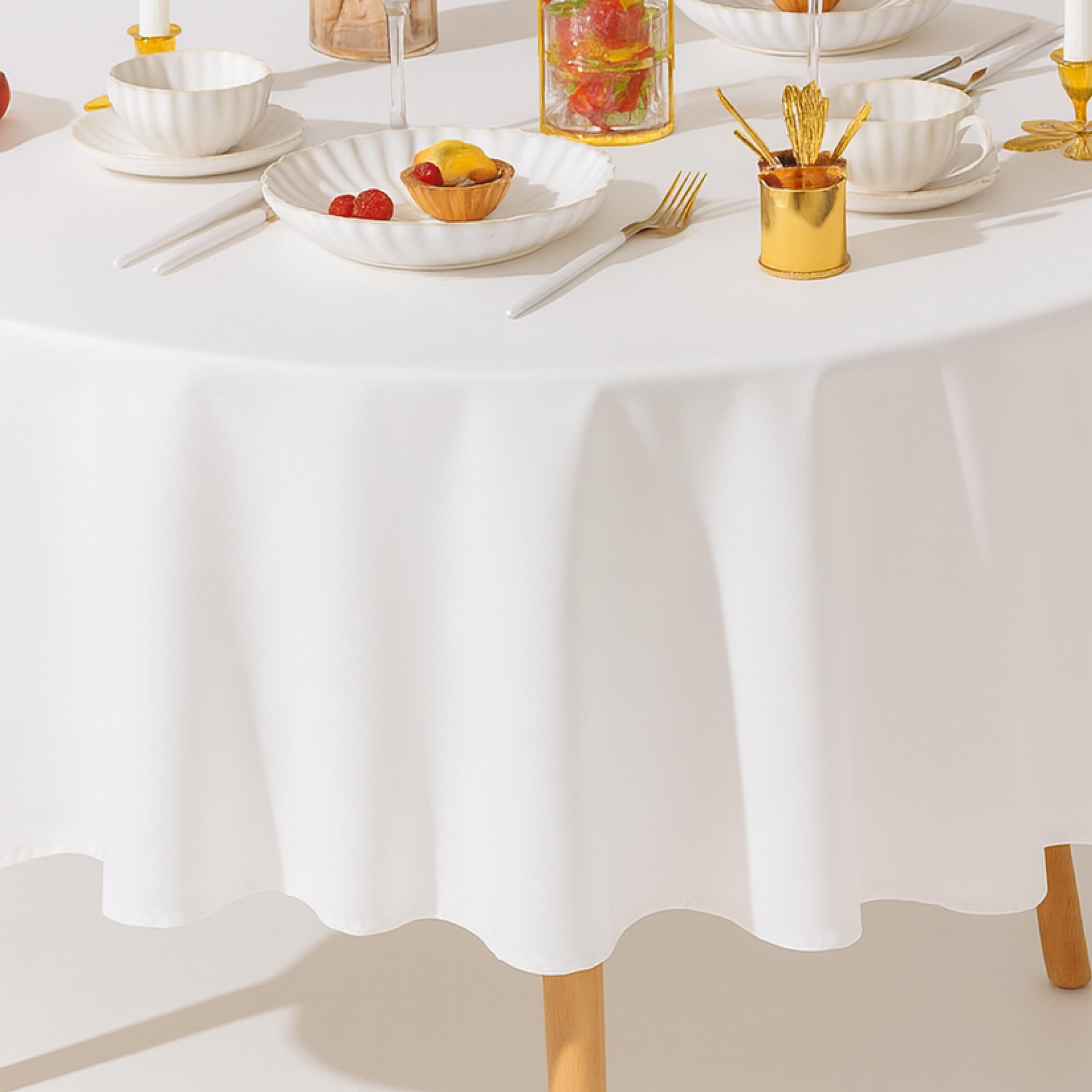 Wealuxe dining event tablecloth draped over a round table.