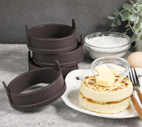 Webake silicone crumpet rings in pan delivering evenly cooked English muffins.