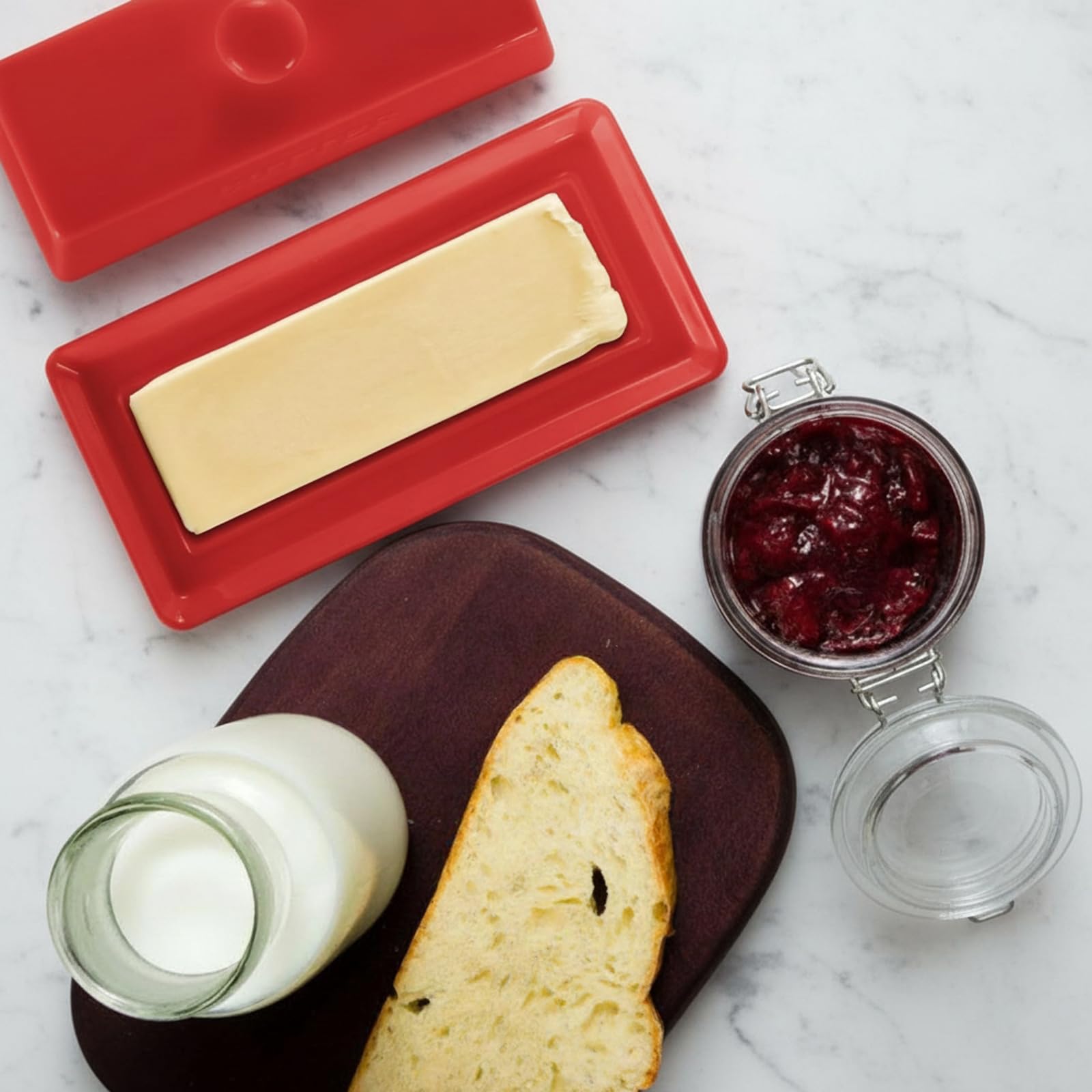 Elegant red butter dish adding style to kitchen decor.