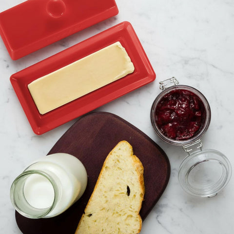 Elegant red butter dish adding style to kitchen decor.