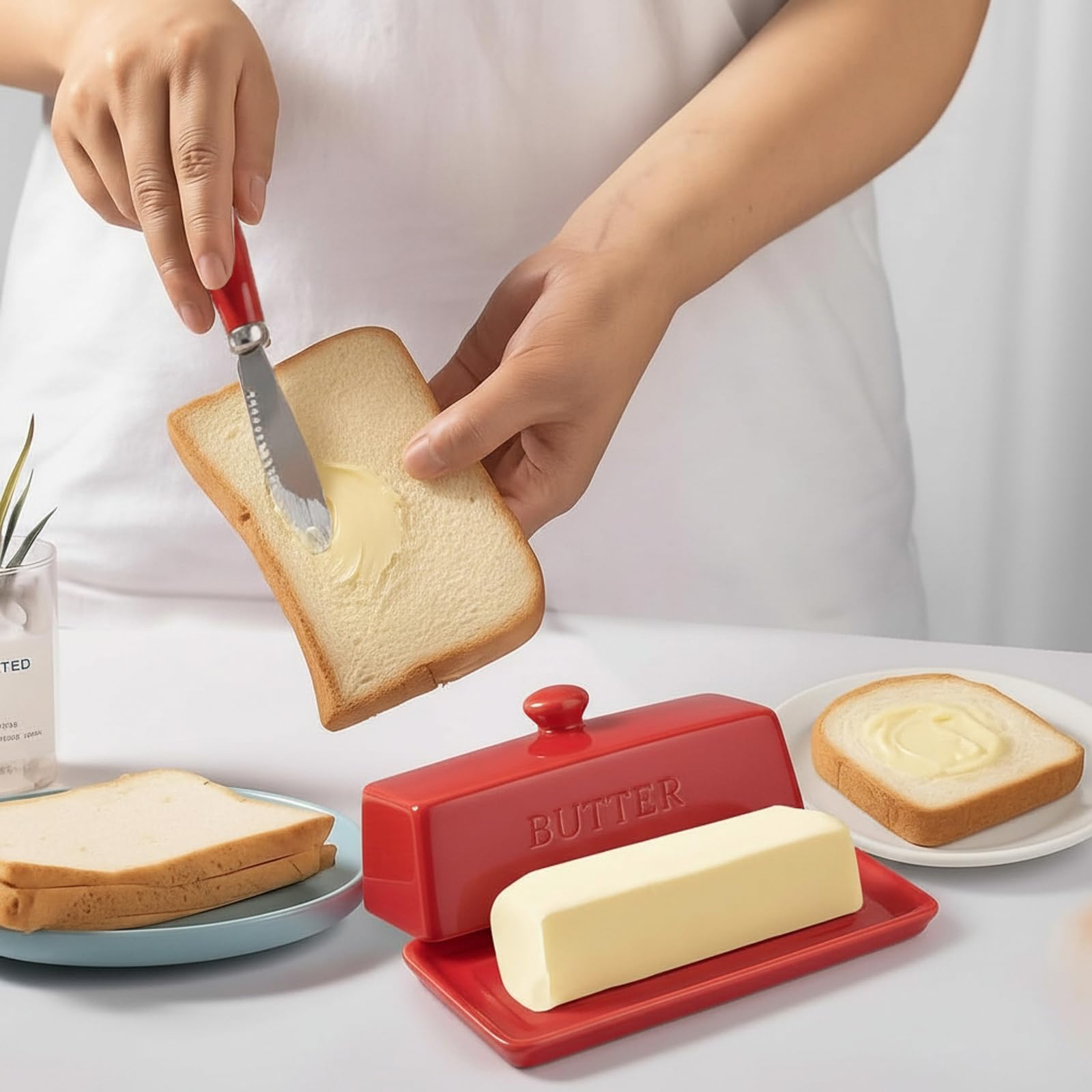 Red enameled knife handle complements the WERTIOO butter dish.