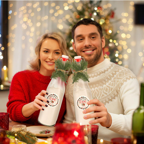 Whaline Christmas table decor setup using bottles and pine accents