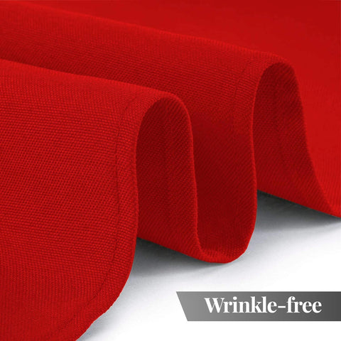 White Classic Wealuxe red tablecloth on a dining table during setup.