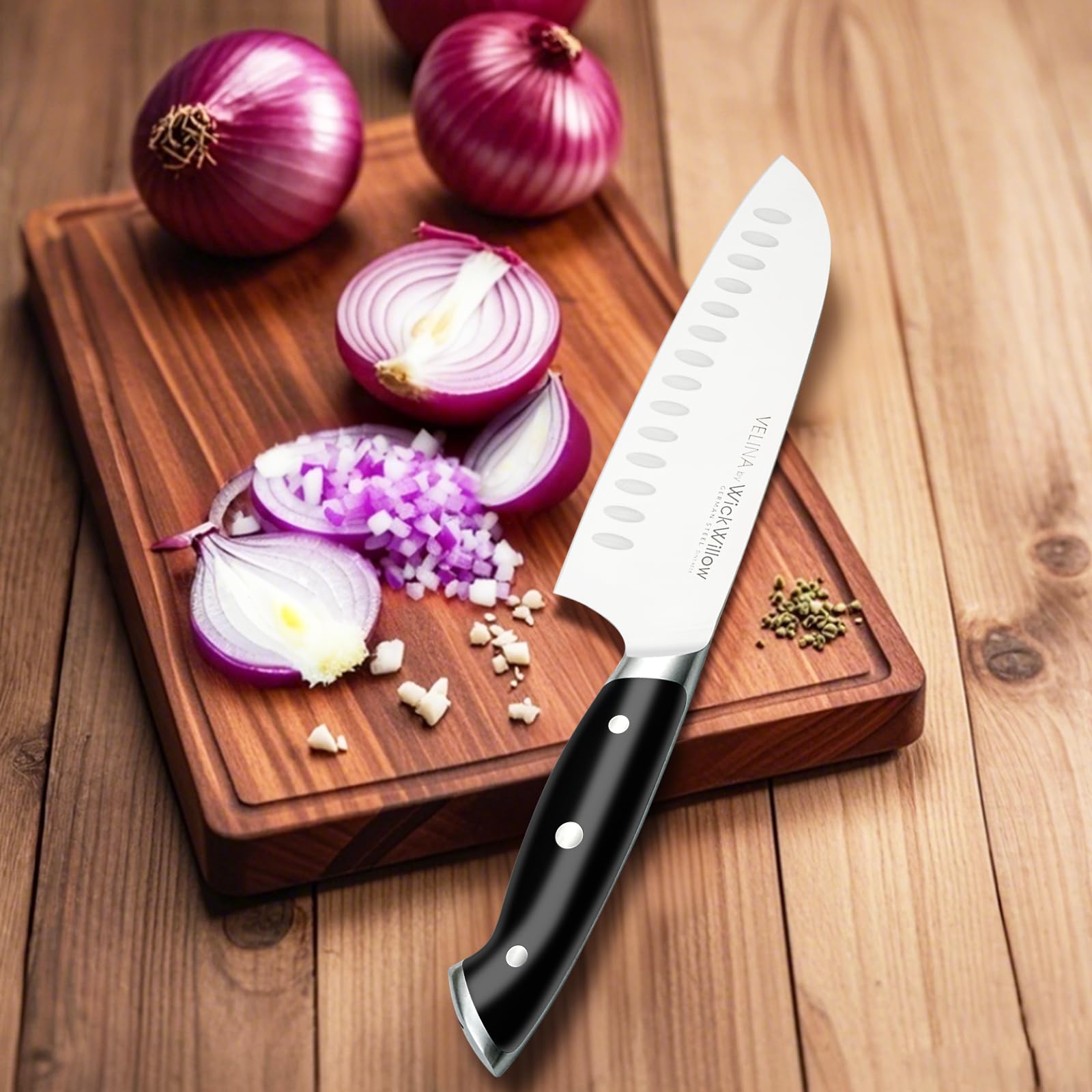 WICKWILLOW Velina Santoku blade profile against a board showing balanced weight.
