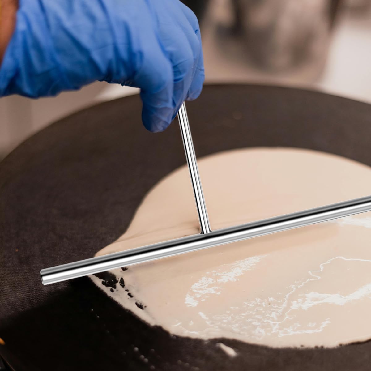 Windesk spatula with hanging hole designed for wall storage.