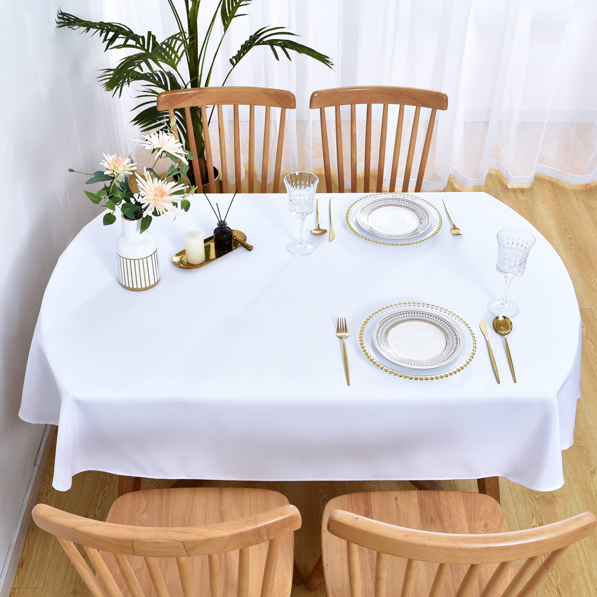 Wolkemer oval tablecloth setting creates refined dining ambience.