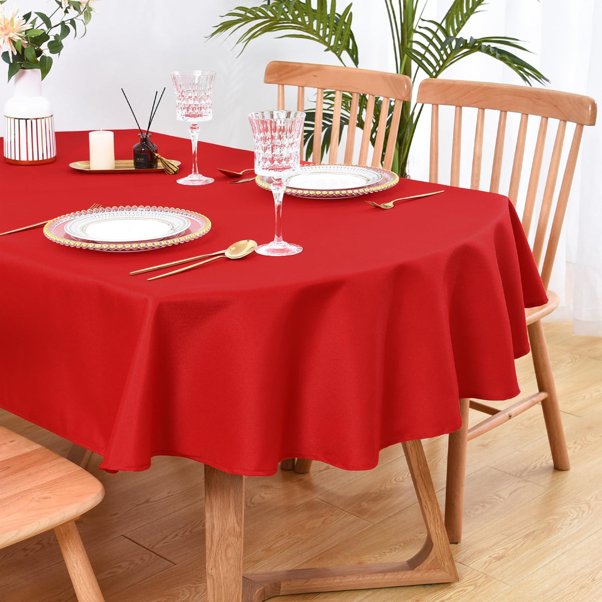 Wolkemer oval tablecloth in solid red protects tables during festive dining.