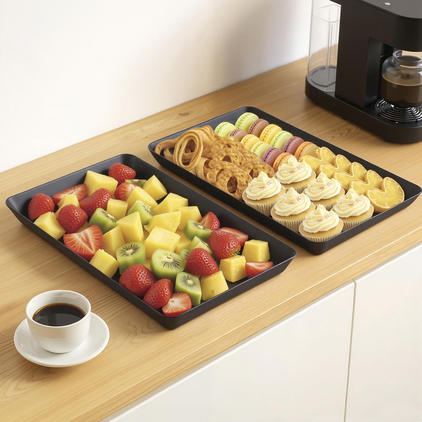 WOWBOX black plastic trays displaying fruit and cookies for guests