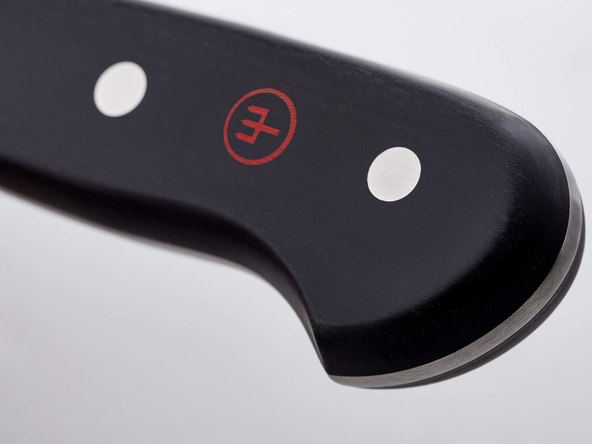 Wüsthof Classic boning knife meat-trimming detail for precise cuts.
