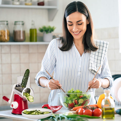X Home rotary cheese grater in action shredding vegetables for a fresh dish.