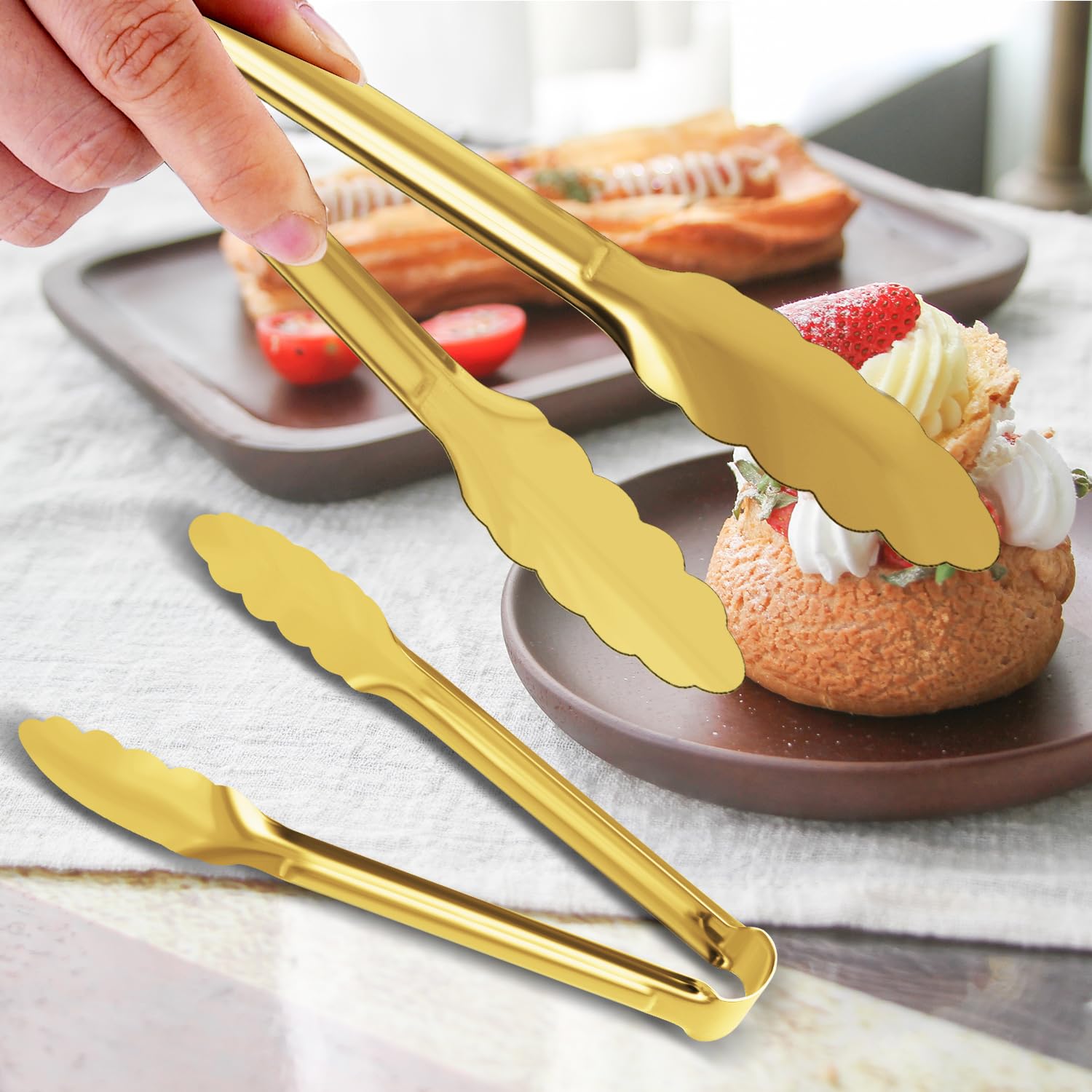 XEVOM gold-plated tongs close-up showing durable stainless steel core.