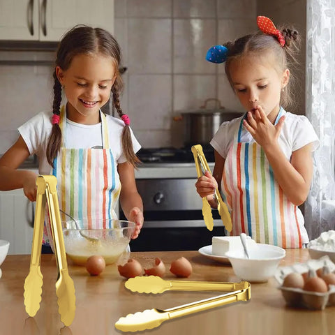 XEVOM gold serving tongs close-up grip and edge detail.