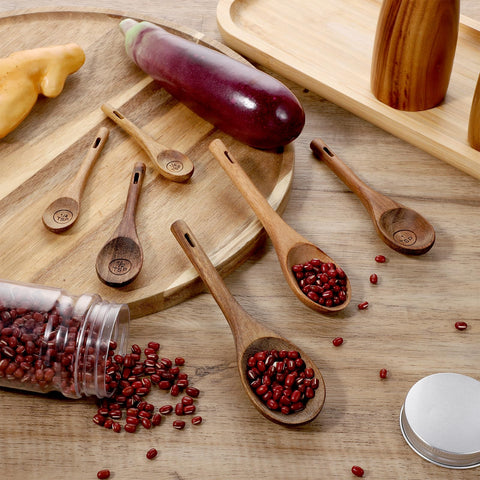 Xyembu spoons in spice jar demonstrating easy access and spill prevention.