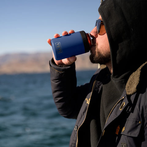 Navy Colster in use at a tailgate with standard cans